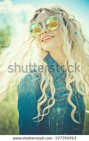 Fashion portrait of young hippie woman in summer sunny day
