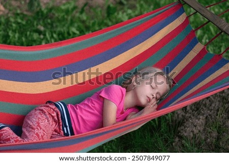 Similar – Image, Stock Photo A blonde girl lies in the forest in a flowering meadow in the clearing with small white flowers and looks up at the camera