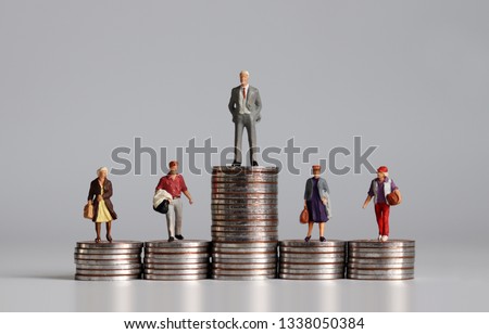 Miniature people with stack of coins. A concept of income inequality. ストックフォト © 