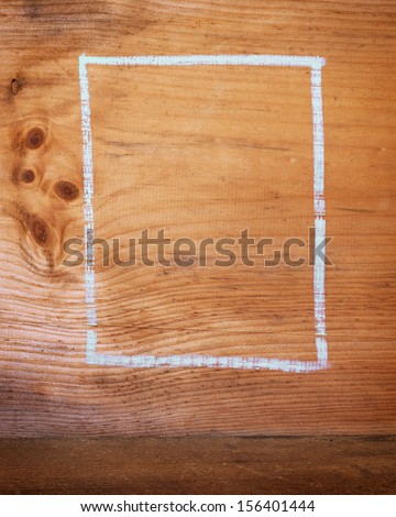 A chalk box outline drawn a wooden board for background or texture.