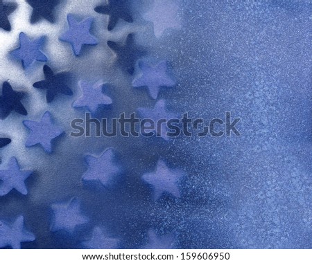 A background illustration make from blue and white spray paint with stars for background or texture.