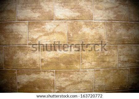 A flat wall made with textured stone tiles with lots of detail and texture for background.