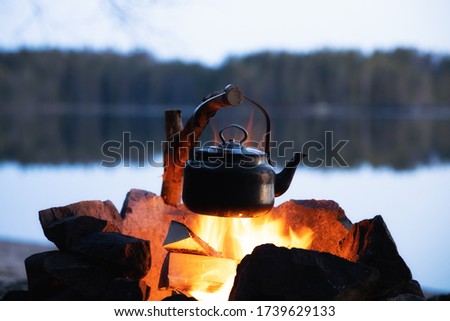 Similar – Image, Stock Photo Kettle placed on campfires in snowy woods at sundown