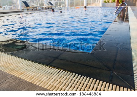 Swimming pool, Beautiful refreshing blue tiles pool with ripple water reflection.