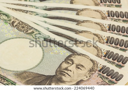 Japanese Yen banknotes on white background.
