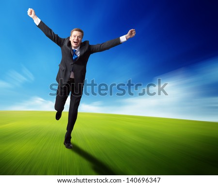 happy business man running on blured spring field