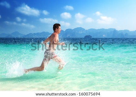 running man in water of tropical sea