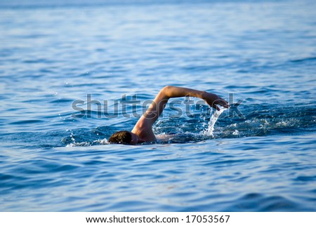 swimming man in ocean water