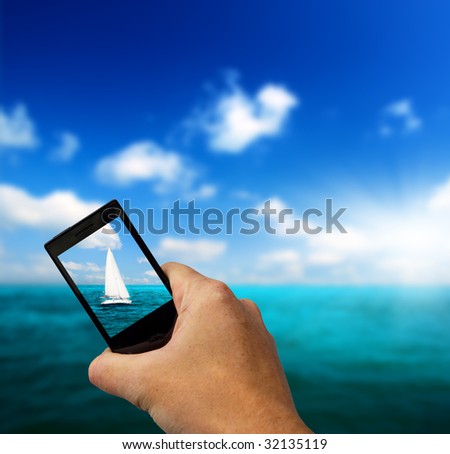 sailboat sky and cell phone in hand