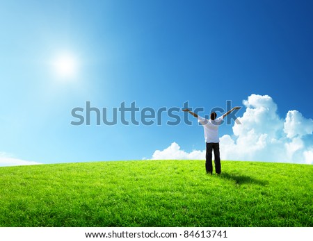 happy young man on green field
