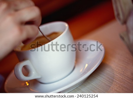 Close Up Of Man\'s Hand Mixing Coffee With Spoon