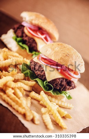 Ground beef Cheese Burger with Lettuce,Tomato and Red Onion with French Fries