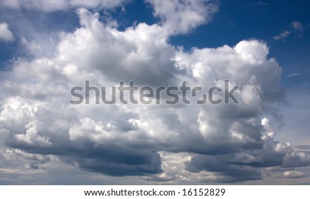 Big clouds in the blue sky in sunny weather