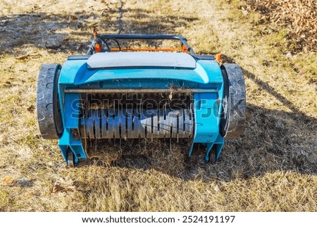 Similar – Image, Stock Photo Spring gardening. Scarifying in the garden to improve the quality of the lawn in the spring.