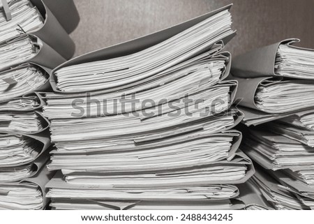 Similar – Image, Stock Photo A messy stack of file folders lies on a desk