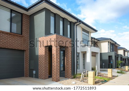 Building of some residential townhouses in a suburb of Australia. The exteriors of some two-story modern Australian suburban homes. 