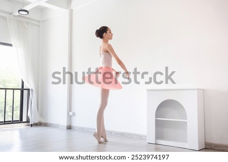 Similar – Foto Bild Ballerina-Tänzerin beim Aufwärmen des flexiblen Körpers im sonnigen Studio.