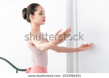 Similar – Foto Bild Ballerina-Tänzerin beim Aufwärmen des flexiblen Körpers im sonnigen Studio.