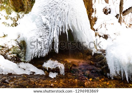 The dome of the ice over the waterfall Raduzhny, from which a small stream flows, Russia Сток-фото © 