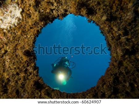 Diver with underwater light  through window