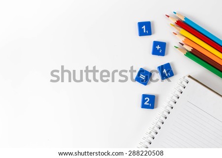 White background with a book ,number blocks and crayons