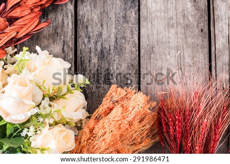 rose ,hay and dry leaves on old wood background