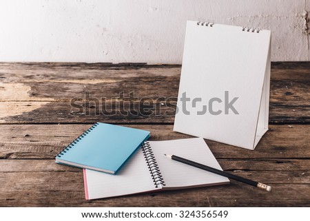 Calendar,pencil and book on wooden floor