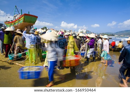 CIRCA APRIL 2011 - QUY NHON, VIETNAM - Women trade seafood at the beach, on 3 April 2011, in Quy Nhon, Vietnam