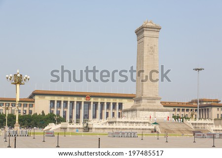 BEIJING, CHINA - MAY 18, 2014- Monument to the People\'s Heroes in the centre of Tiananmen Square, with the Great Hall of the People in the background, Beijing