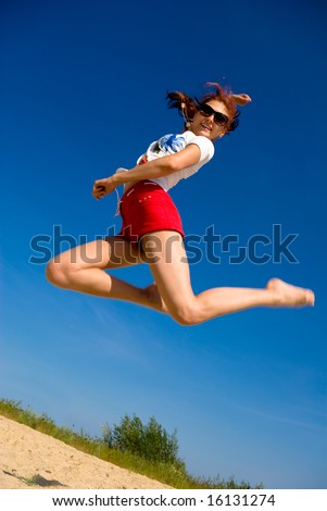 Young girl leaps into the air, jumps for joy