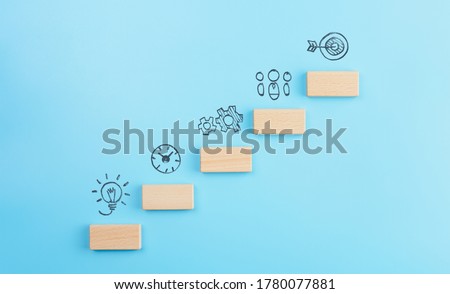 Business development strategy, Action plan and goal concepts, wooden cubes stacking as step stair with icons business strategy on blue background. copy space Сток-фото © 