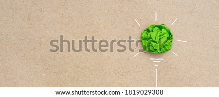 Green crumpled paper light bulb, Corporate Social Responsibility (CSR), eco-friendly business and environmental concept with copy space