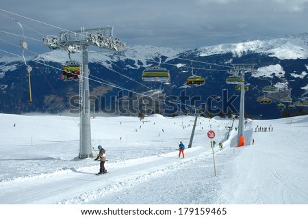 KALTENBACH, AUSTRIA - FEB04: Ski lifts and unidentified skiers on drag and chair lifts nerby nearby Kaltenbach in Zillertal in Austria 04.02.2014