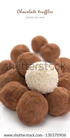 Chocolate truffles with sweet cream inside on the white background