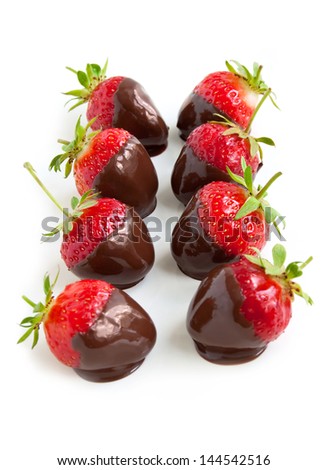 Row of strawberries dipped in delicious chocolate isolated on the white background