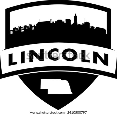 City of Lincoln Nebraska black and white shield style city buildings silhouette shield graphic with knockout white outline of the state border shape under name. Vector eps design. 