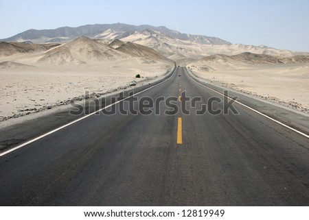 Typical Peruvian road with sand rolling landscape. Peru