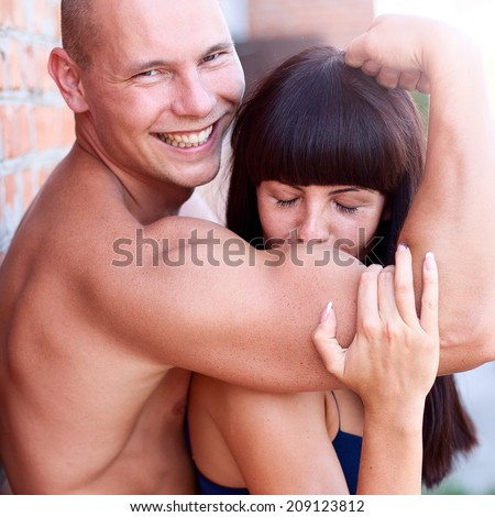 Athletic beauty man and sexy girl kissing hand