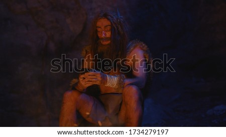 Similar – Image, Stock Photo This wild man is playing with fire. Dressed in fur during this cold winter’s night he is doing some dangerous tricks. Becoming a firestarter.
