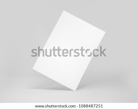 Rectangular blank paper standing on its angle, with shadows, isolated on a white background
