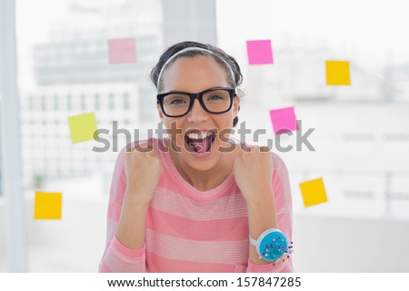 Happy woman in creative office smiling at camera
