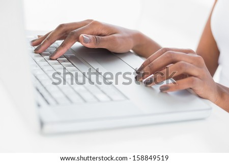 Close up on woman\'s hands using her laptop in bright fitness studio