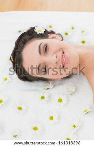 Close up portrait of a beautiful young woman with flowers in beauty salon