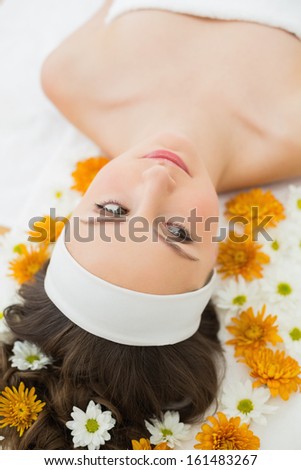 Overhead view of a beautiful young woman with flowers in beauty salon
