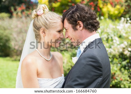 Pretty blonde wife hugging her new husband in the countryside