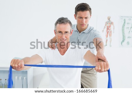 Male therapist massaging mans shoulder in the hospital
