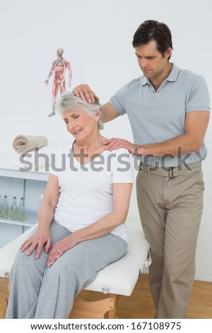 Senior woman getting the neck adjustment done in the medical office