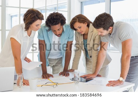 Concentrated young business people in meeting at office desk