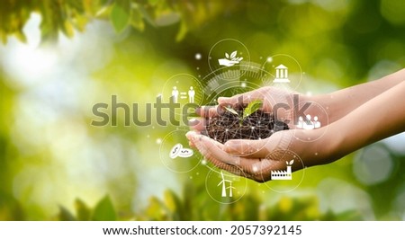 Hand planting trees with technology of renewable resources to reduce pollution ESG icon concept in hand for environmental, social and sustainable business governance. Stock foto © 