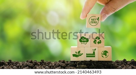 Net Zero and Carbon Neutral Concepts Net Zero Emissions Goals A climate-neutral long-term strategy Ready to put wooden blocks by hand with green net center icon and green icon on gray background. 商業照片 © 
